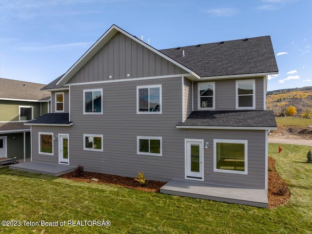 rear view of property with a yard and a patio