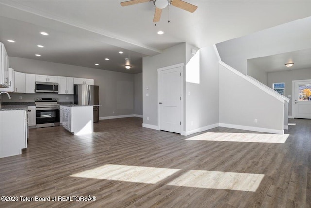 unfurnished living room featuring ceiling fan and hardwood / wood-style floors