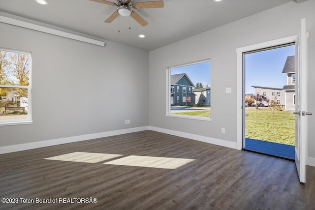 spare room featuring ceiling fan and dark hardwood / wood-style flooring