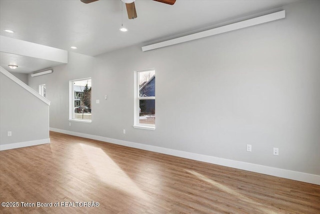 unfurnished room featuring ceiling fan and light hardwood / wood-style flooring