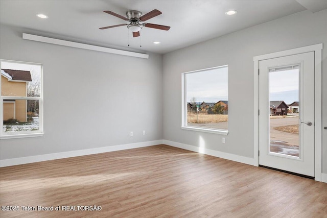 spare room with ceiling fan and light hardwood / wood-style flooring