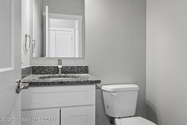 bathroom with vanity and toilet