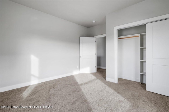 unfurnished bedroom featuring a closet and carpet