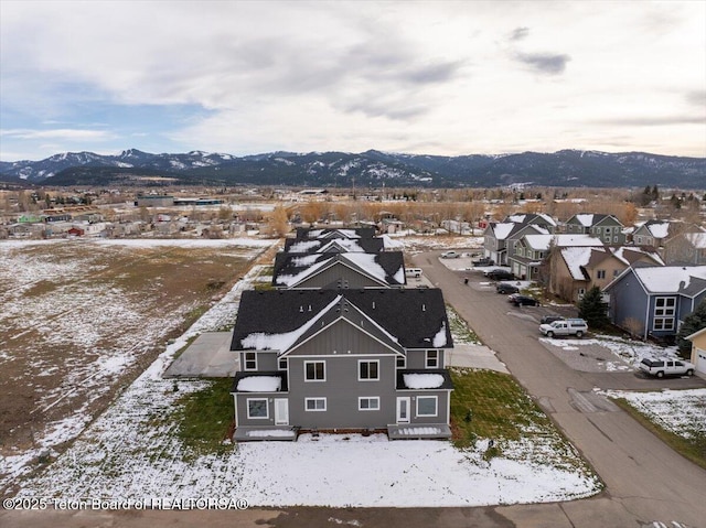 snowy aerial view featuring a mountain view