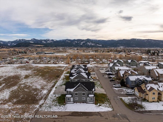 snowy aerial view with a mountain view