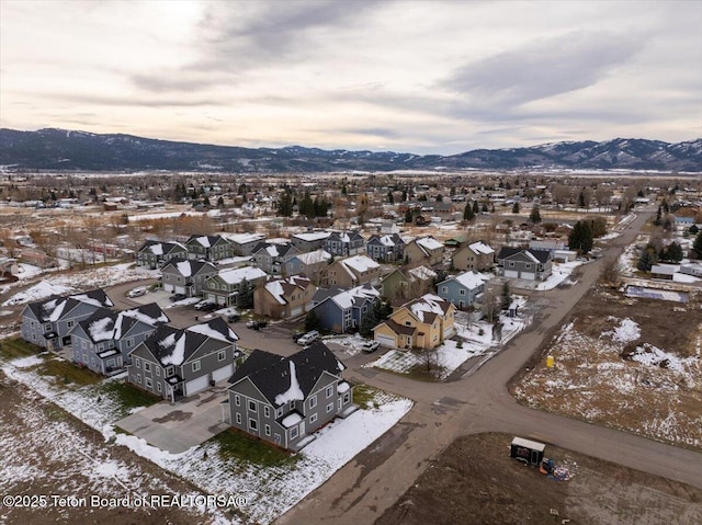 snowy aerial view with a mountain view