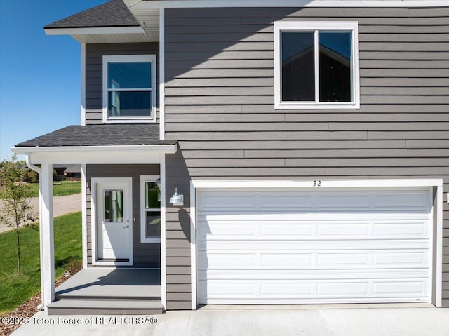 90 Alpine Trl Unit 31, Victor, ID 83455 - view of front of property with a garage and roof with shingles