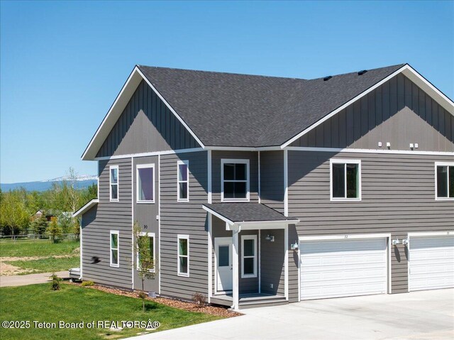 90 Alpine Trl Unit 31, Victor, ID 83455 - view of front facade with a shingled roof, a garage, driveway, and board and batten siding