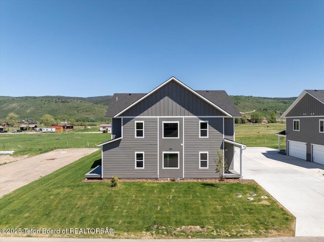 90 Alpine Trl Unit 31, Victor, ID 83455 - view of home's exterior featuring board and batten siding, driveway, a lawn, and a garage