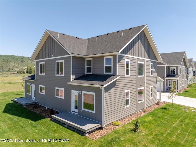 90 Alpine Trl Unit 31, Victor, ID 83455 - rear view of house with board and batten siding, roof with shingles, and a yard