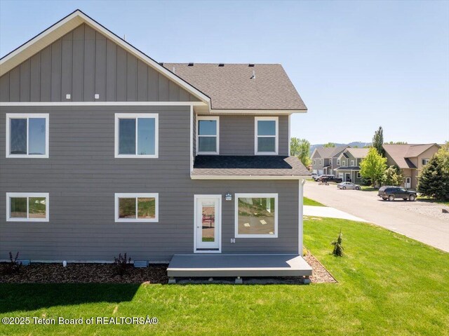 90 Alpine Trl Unit 31, Victor, ID 83455 - rear view of property featuring board and batten siding, a lawn, and a shingled roof