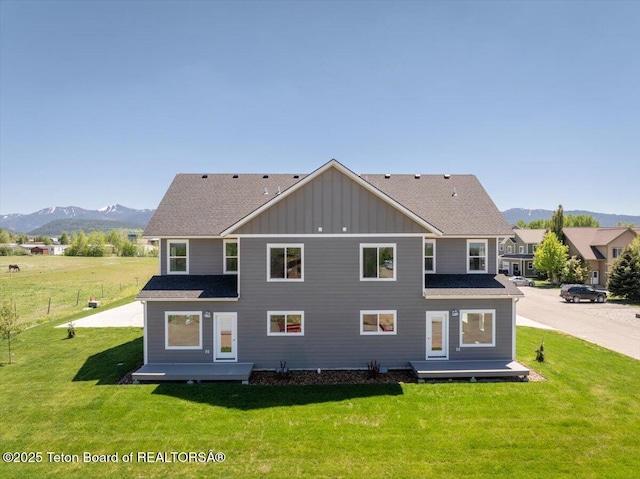 90 Alpine Trl Unit 31, Victor, ID 83455 - back of house with board and batten siding, a mountain view, and a yard