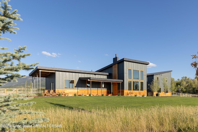 rear view of property featuring a yard