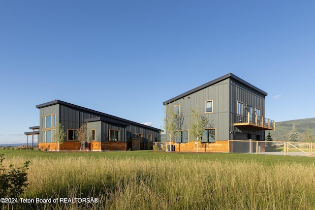 3176 Slinger Ct, Driggs, ID 83422 - rear view of property featuring central AC and board and batten siding