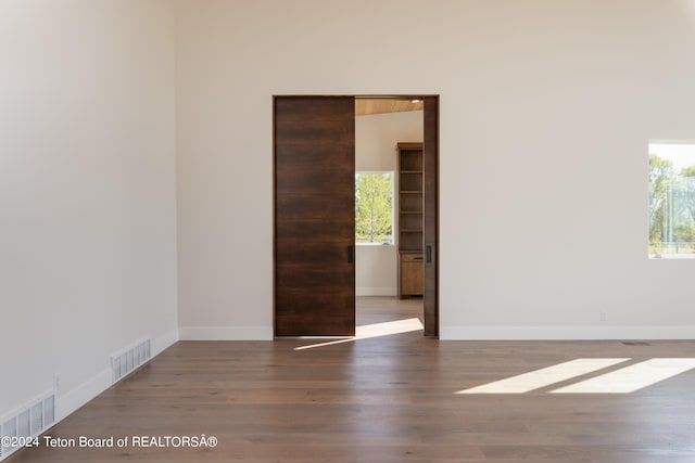 3176 Slinger Ct, Driggs, ID 83422 - unfurnished room featuring wood finished floors, baseboards, and built in shelves