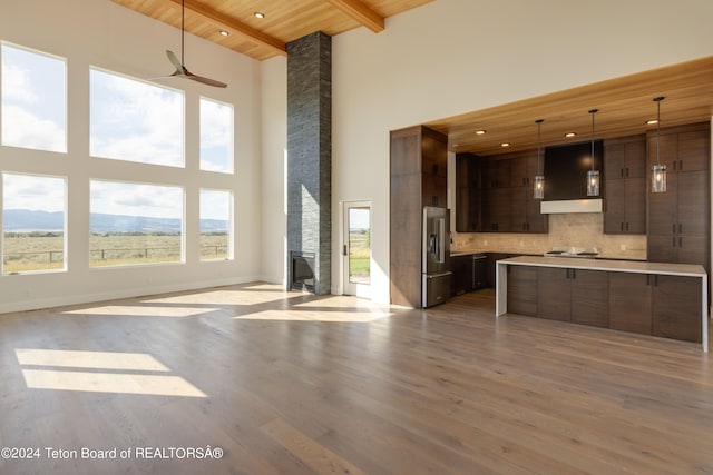 kitchen featuring high end fridge, light wood-type flooring, high vaulted ceiling, and wooden ceiling