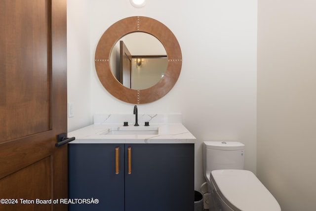 bathroom with vanity and toilet