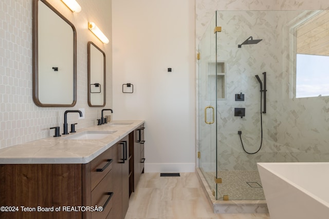 3176 Slinger Ct, Driggs, ID 83422 - bathroom featuring a marble finish shower, a soaking tub, double vanity, decorative backsplash, and baseboards