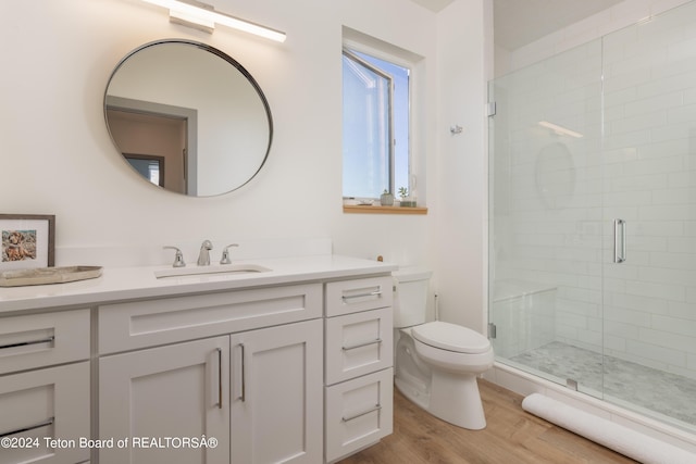 3176 Slinger Ct, Driggs, ID 83422 - bathroom featuring vanity, a shower stall, toilet, and wood finished floors