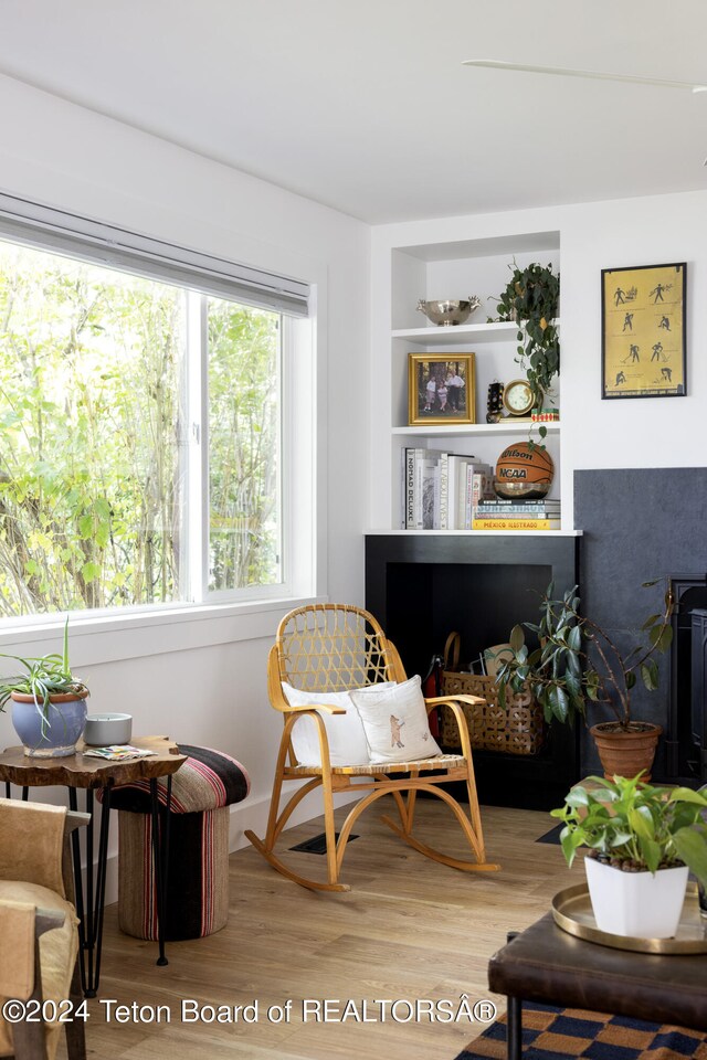 sitting room with hardwood / wood-style flooring