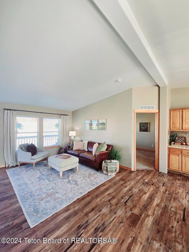 living room with lofted ceiling and dark hardwood / wood-style flooring