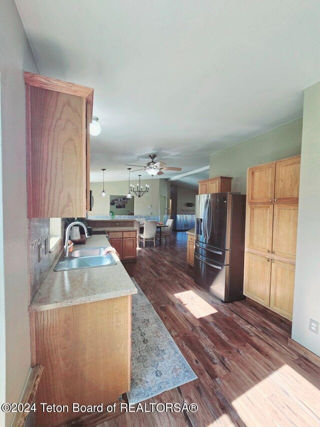 kitchen with dark hardwood / wood-style floors, sink, kitchen peninsula, ceiling fan, and stainless steel fridge