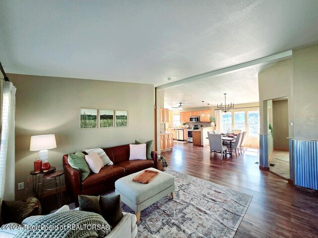 living room featuring a textured ceiling and dark hardwood / wood-style floors