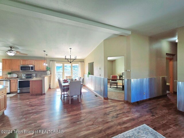 dining space with ceiling fan with notable chandelier, beamed ceiling, and dark wood-type flooring