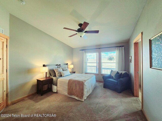 carpeted bedroom with vaulted ceiling and ceiling fan