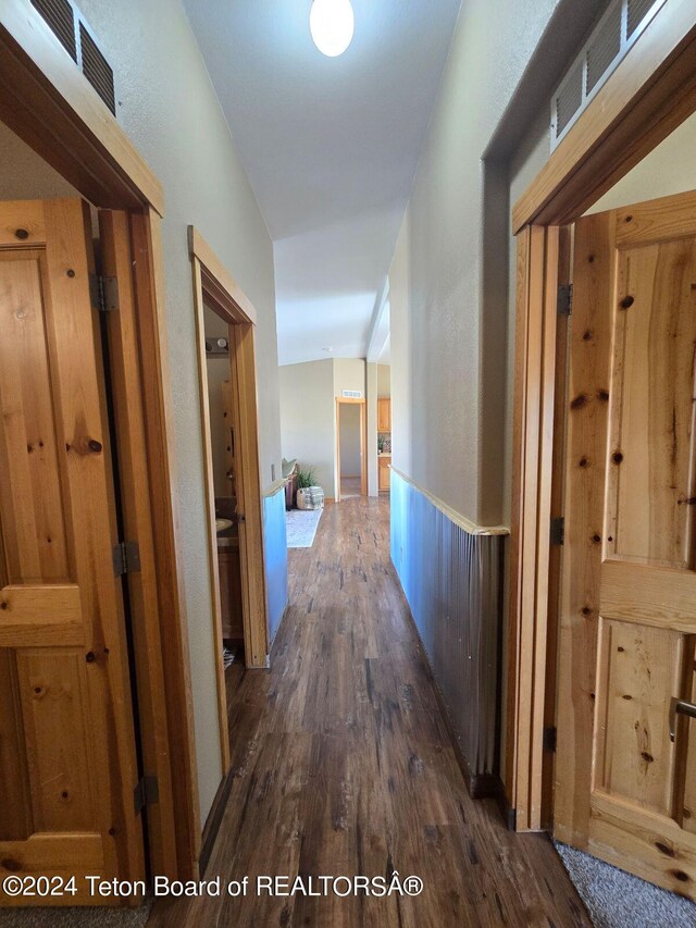 corridor featuring dark hardwood / wood-style floors