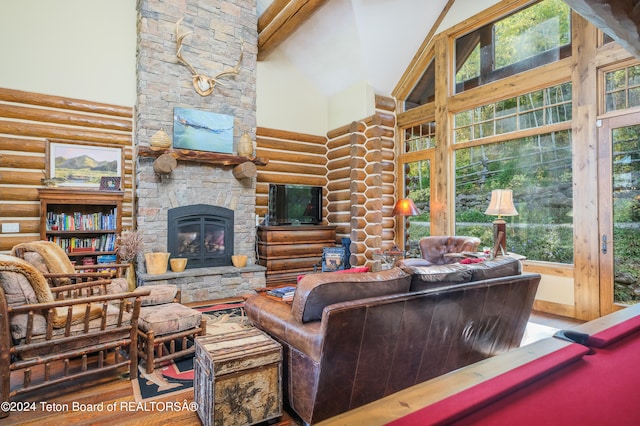 living room featuring beamed ceiling, a stone fireplace, high vaulted ceiling, billiards, and hardwood / wood-style floors