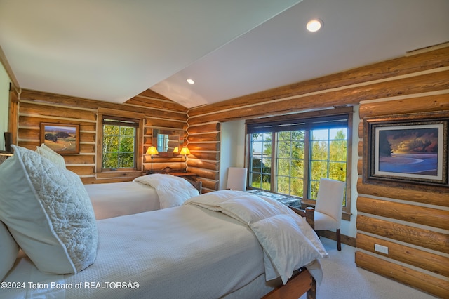 bedroom featuring lofted ceiling, rustic walls, carpet flooring, and multiple windows