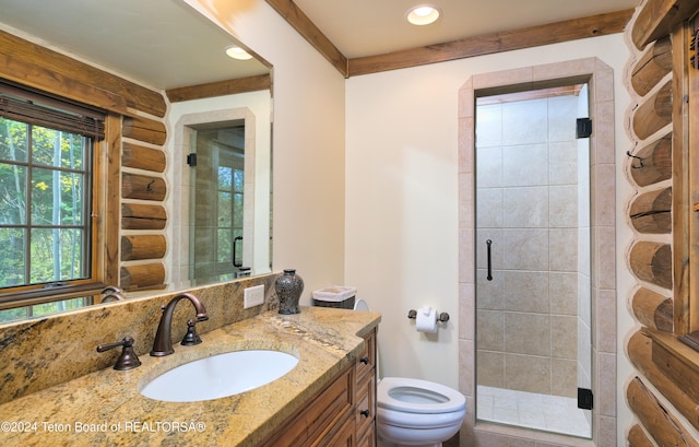 bathroom with walk in shower, vanity, and toilet