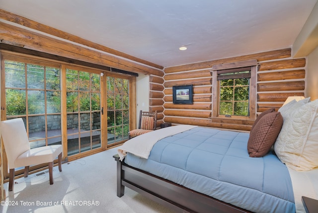 carpeted bedroom with rustic walls and multiple windows