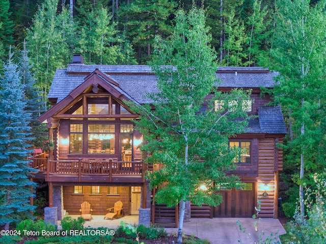 log-style house featuring a deck