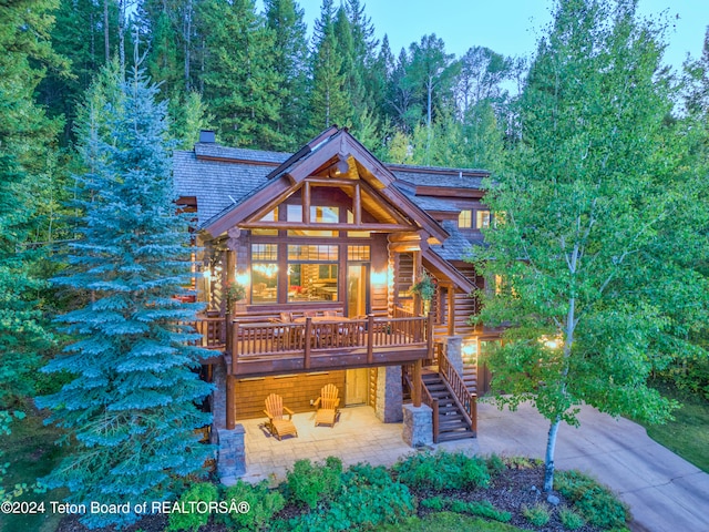 rear view of property with a wooden deck