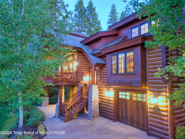 log-style house with a wooden deck