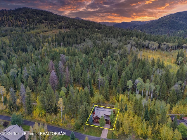 aerial view at dusk featuring a mountain view