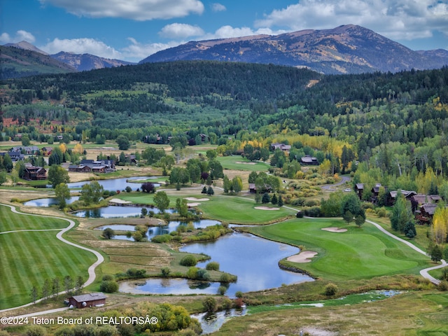 aerial view featuring a water and mountain view