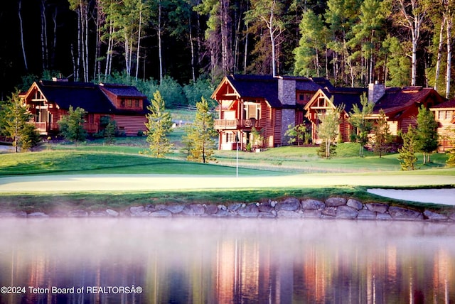 exterior space with a lawn and a water view