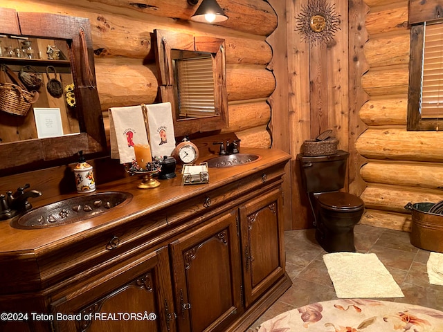 bathroom with sink, log walls, and toilet