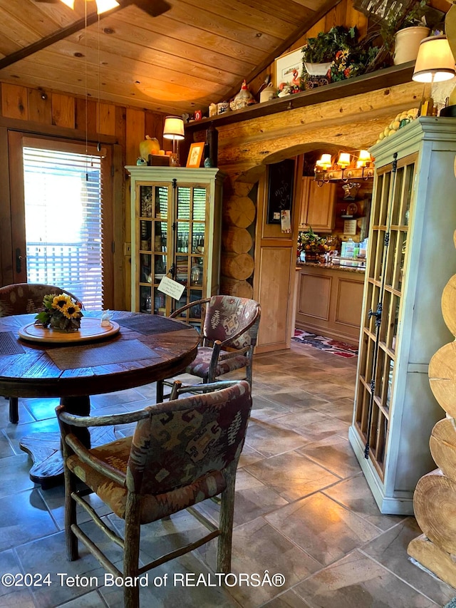 dining area with wood ceiling, french doors, wooden walls, a chandelier, and vaulted ceiling