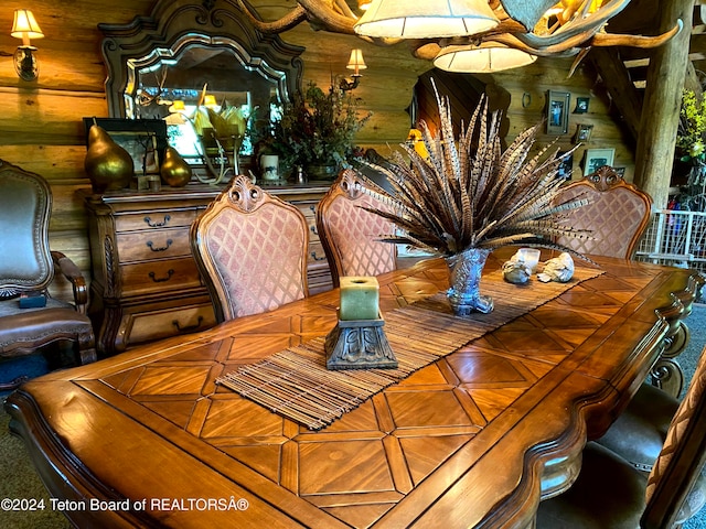 dining area featuring wooden walls