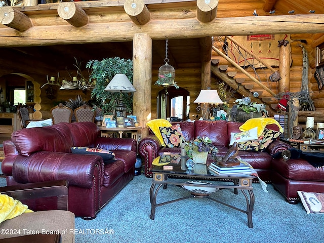 living room featuring carpet, beam ceiling, and rustic walls