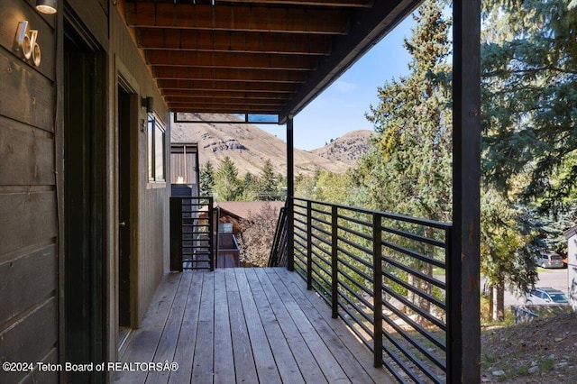 wooden deck with a mountain view