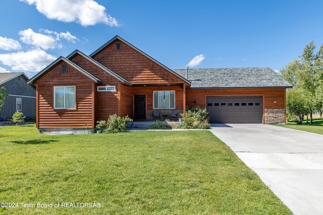 view of front of home with a garage and a front yard