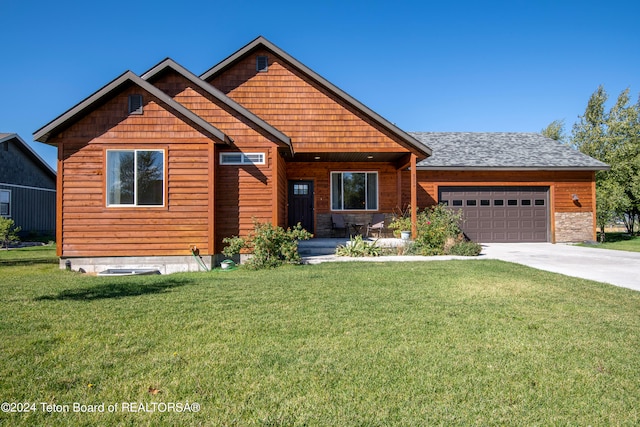 view of front of house featuring a garage and a front lawn