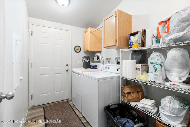 laundry area with light hardwood / wood-style floors, cabinets, and separate washer and dryer