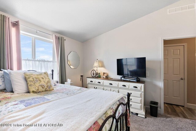 carpeted bedroom featuring lofted ceiling