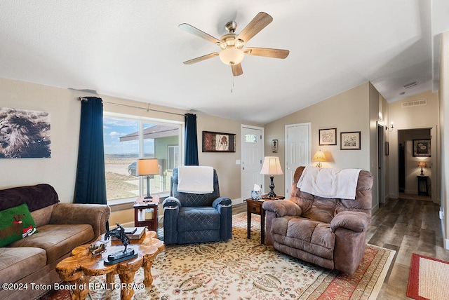 living room featuring hardwood / wood-style flooring, vaulted ceiling, and ceiling fan